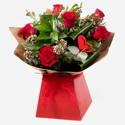Kissing Booth
 - Who could resist you after receiving this selection of the beautiful red roses matched to the finest seasonal foliage.