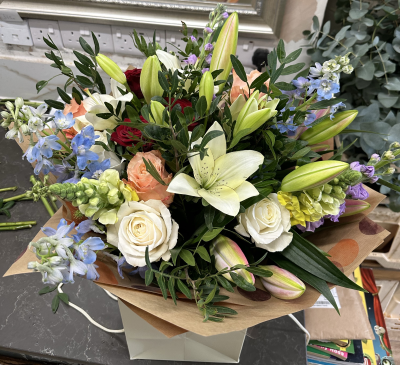 Rainbow - mixed with all mixed colours roses white pink liles blue delphinium yellow snapdragon the picture shows a large vesion please note due to stock we might need to use either colour or same flowers in differnt colours to give the best value